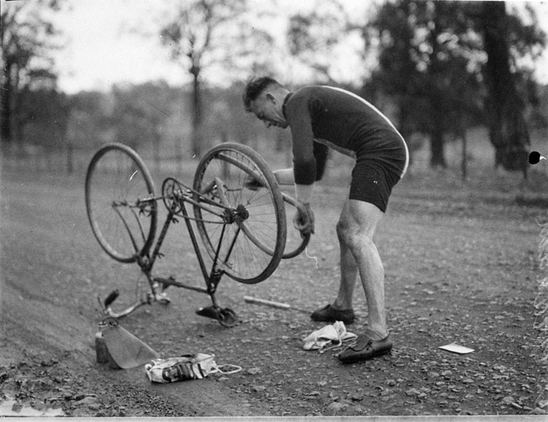 Repairing a puncture during the 1934 Goulburn to Sydney cycle race.
